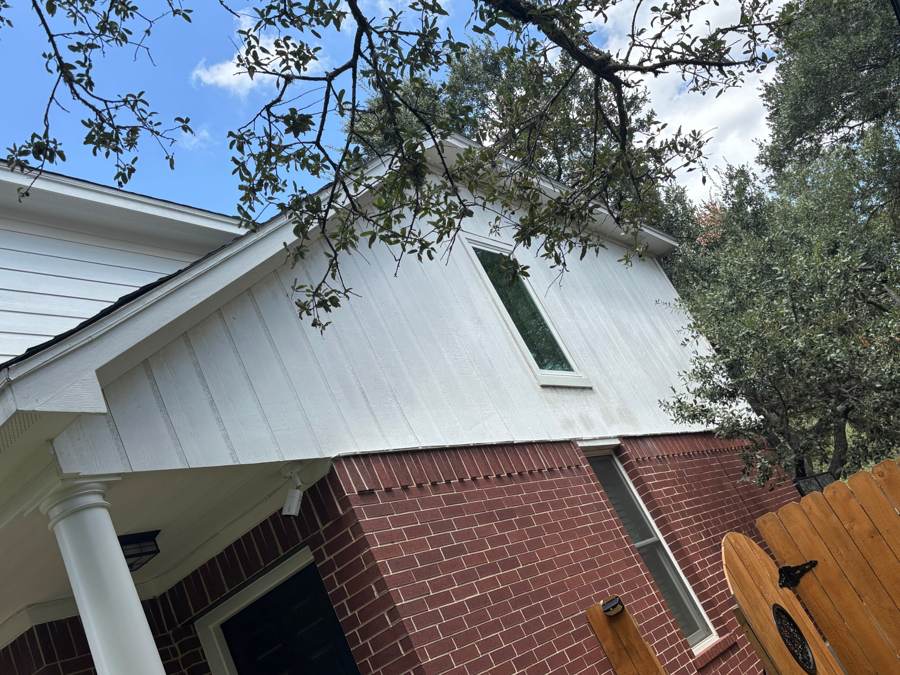 Weathered vertical siding above a front porch