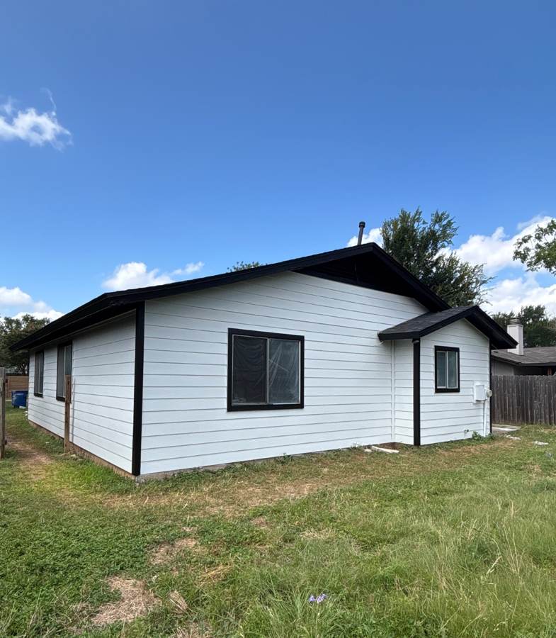 New white lap siding with black trim