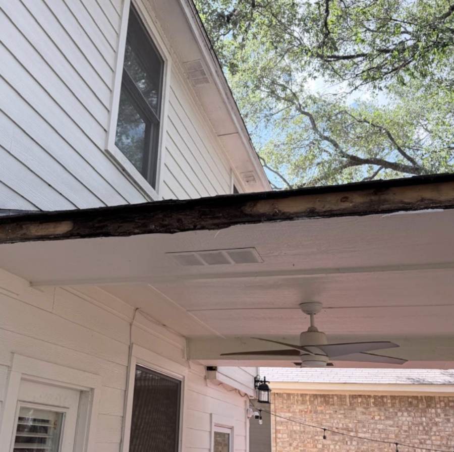 Rotted fascia board along the edge of a patio roof